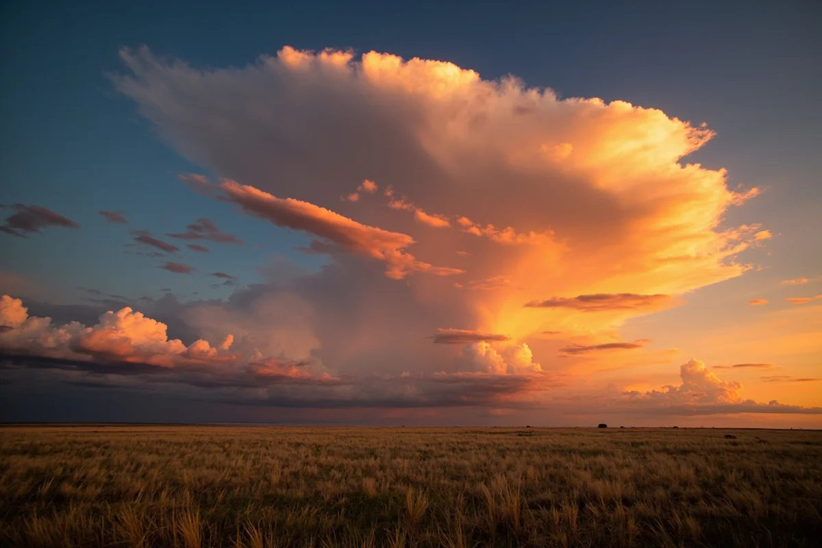 Sunset over Montana prairie with dramatic Big Sky clouds, representing the freedom and open spaces of the state