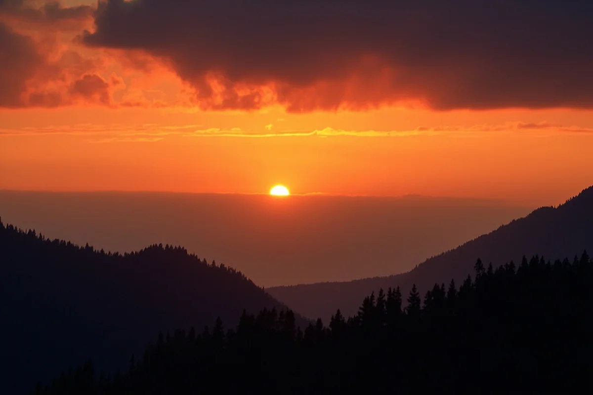 Sunset through smoke haze creating dramatic colors over Montana mountains