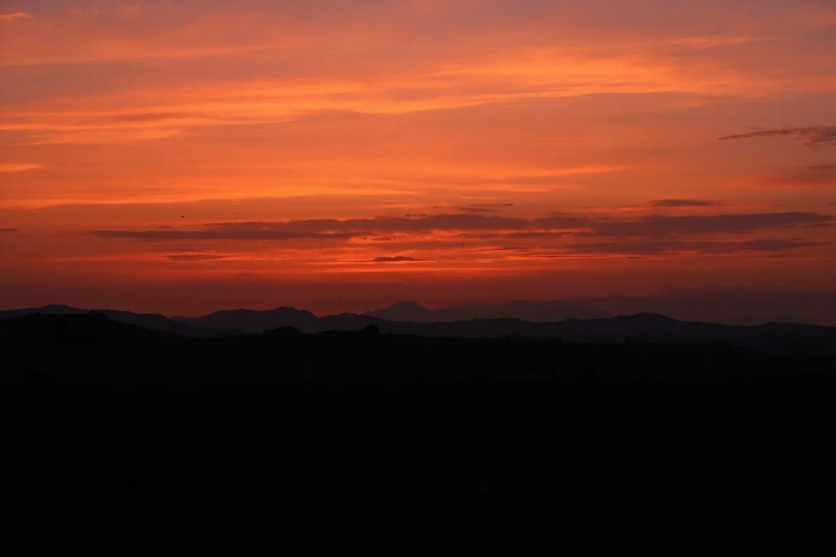 Sunset view over Deer Lodge Valley with prison walls in silhouette