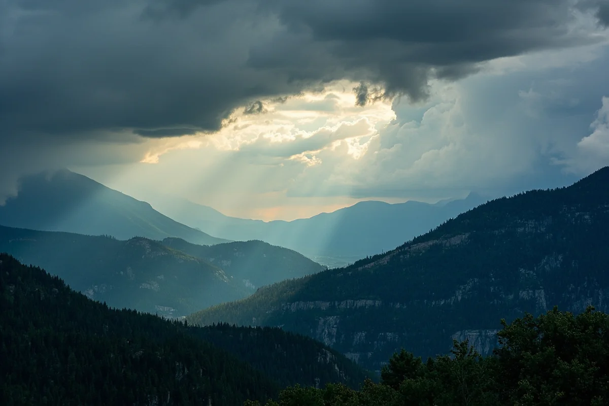 Weather changing rapidly over Montana mountain range, showing sun and approaching storm clouds
