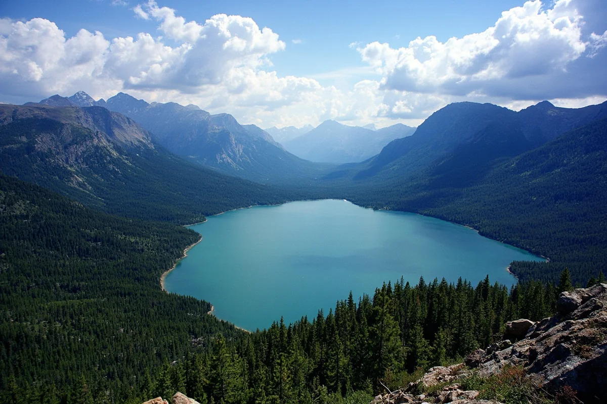 Wide landscape showing Two Medicine Lake from elevated viewpoint with surrounding peaks