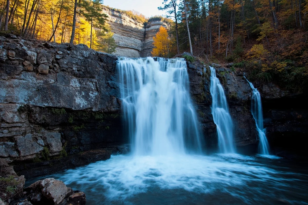 Wide shot of Running Eagle Falls with its distinctive rock face and cascading water