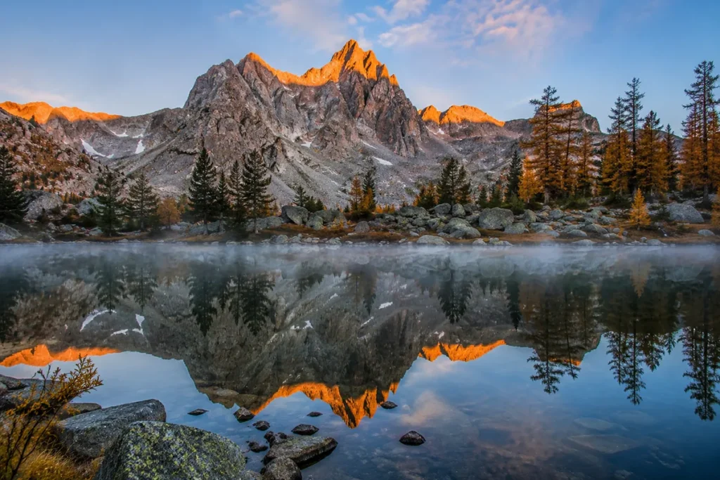 Alpine lake at sunrise in the Tobacco Root Mountains with mountain reflection