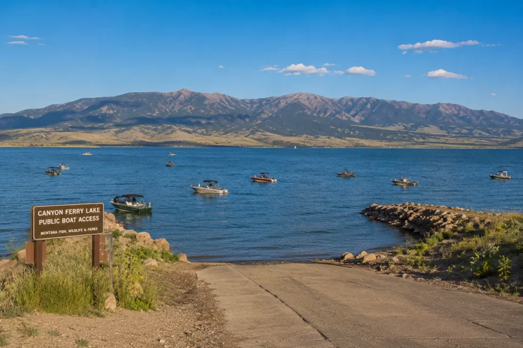 Boat launch at Canyon Ferry Lake with blue water and mountains in Broadwater County Montana