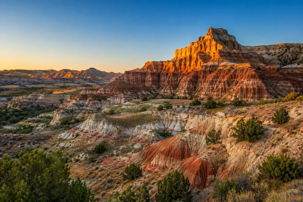 Eroded red and tan badland formations at sunrise in southeastern Montana
