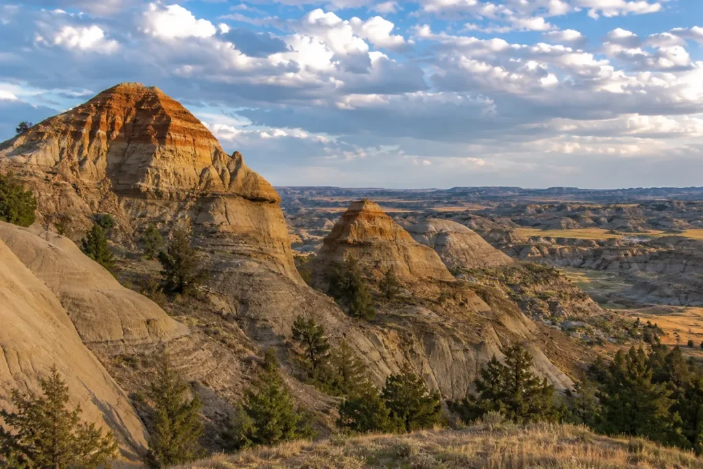 Dramatic badlands formations at Makoshika State Park near Glendive, Montana, with eroded sandstone hills under a wide blue sky