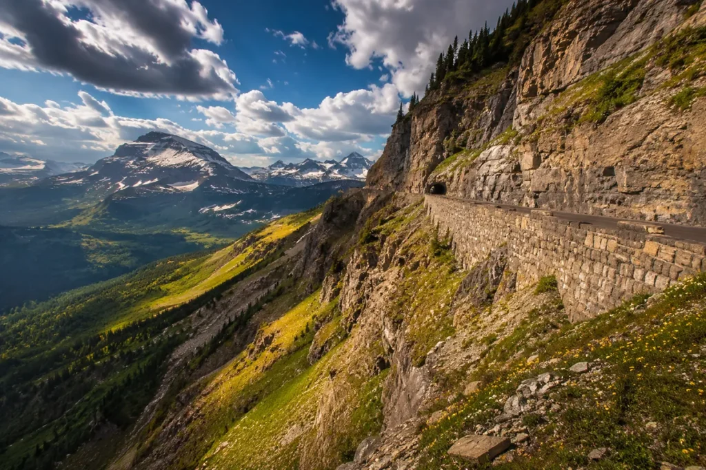 Going-to-the-Sun Road winding along the Garden Wall in Glacier National Park, Montana, with snow-capped peaks and alpine meadows