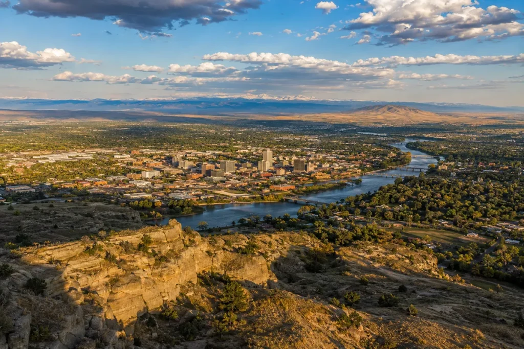 Aerial view of Billings Montana from the Rimrocks with the Yellowstone River winding through downtown and the Beartooth Mountains in the distance