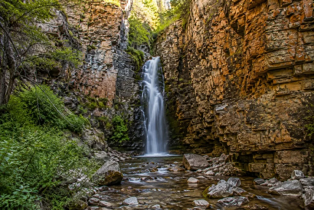 Lost Creek Falls cascading through limestone canyon in the southern Flint Creek Range