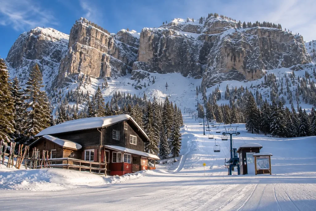 Wide view of Teton Pass Ski Area with the dramatic Rocky Mountain Front rising vertically out of the Montana plains behind the small base lodge and double chairlift