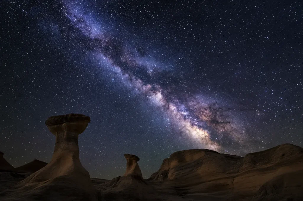 Milky Way over Medicine Rocks State Park sandstone formations at night in Carter County Montana
