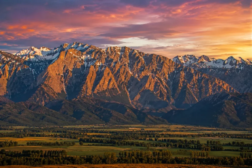 The Bitterroot Mountains rising as a granite wall above the Bitterroot Valley at sunset