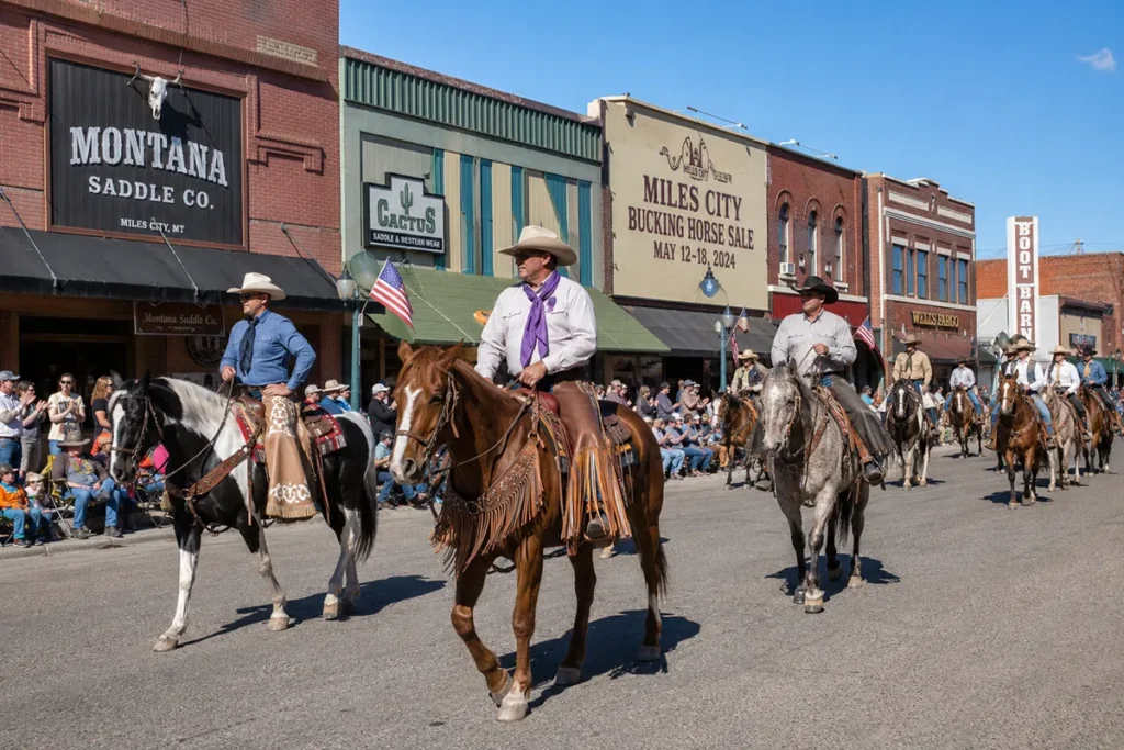 Bucking Horse Sale parade on Main Street in Miles City Montana with cowboys on horseback
