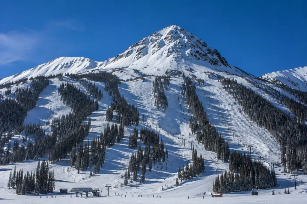 Wide view of Lone Mountain from the Moonlight side showing the north face of the peak with multiple chairlifts and ski runs visible