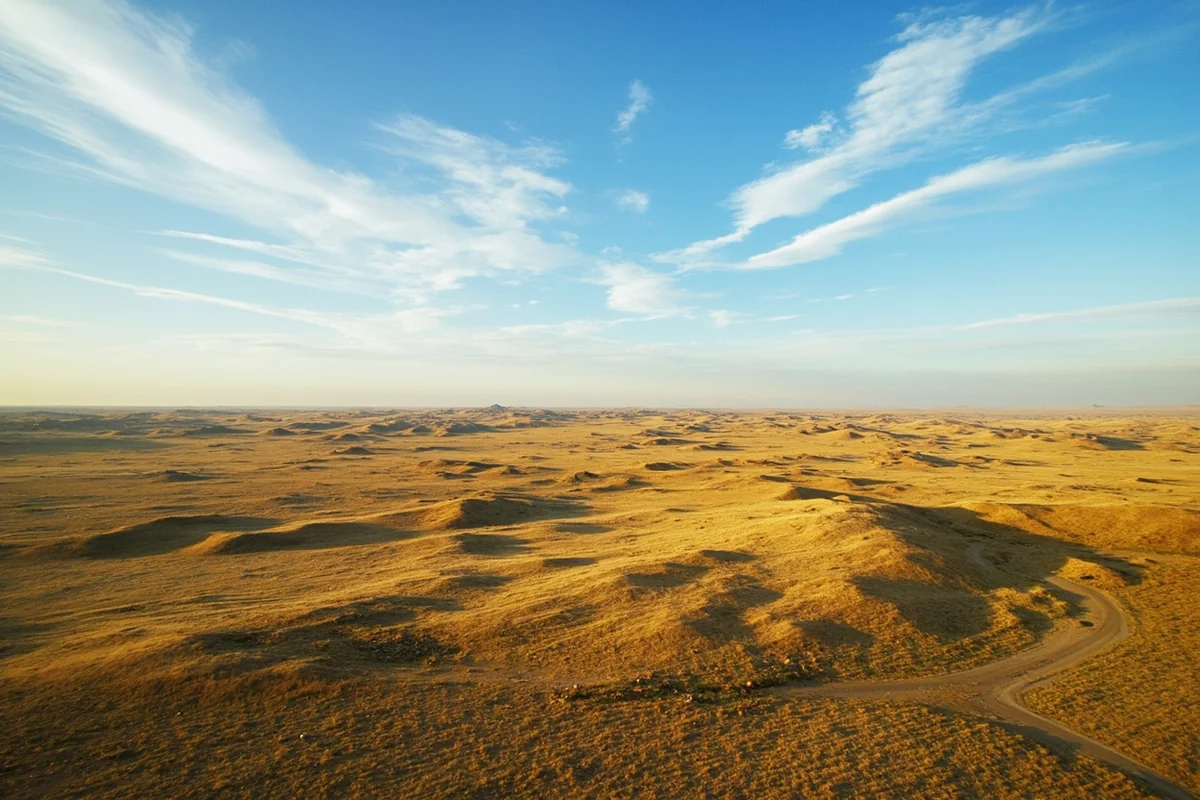 Aerial view of Garfield County prairie landscape showing rolling hills, buttes, and endless sky