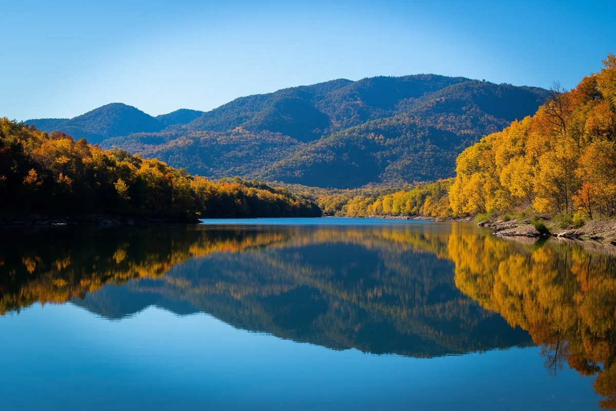 Beaver Creek Lake in Hill County's Bear Paw Mountains, with forested hills reflecting in calm water