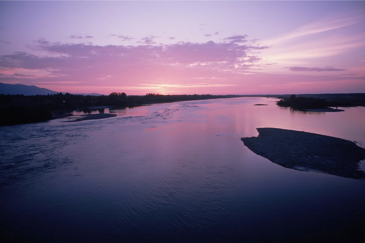 Powder River at sunrise with soft pink light reflecting on slow-moving water, eastern Montana