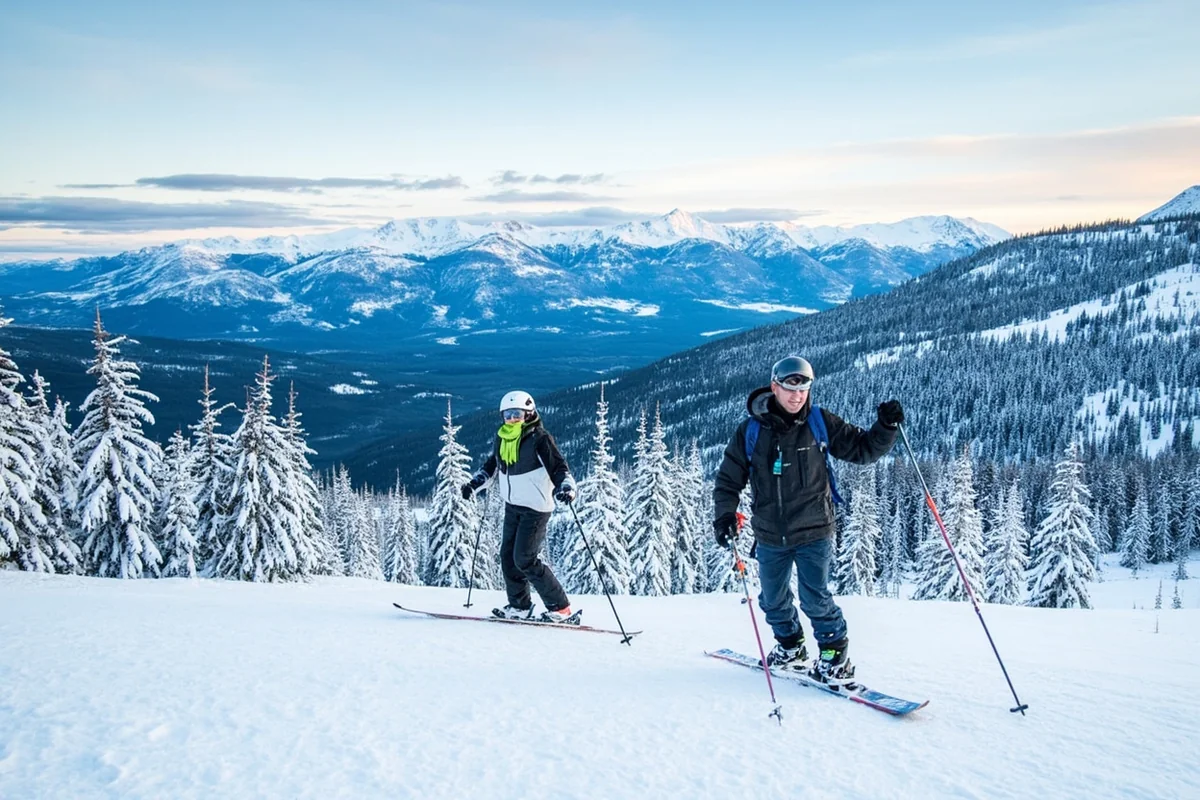 Whitefish Mountain Resort in winter, skiers on slopes with expansive mountain views