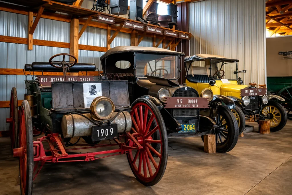 Antique wagon and vehicle collection inside the Wagon Depot building at Range Riders Museum