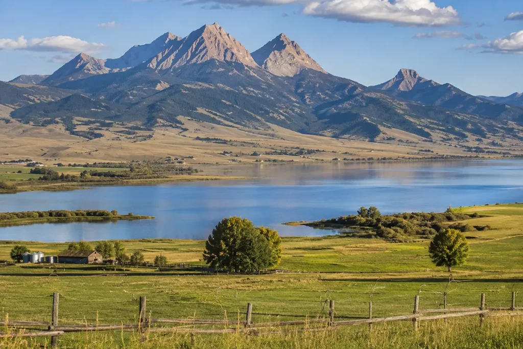 Ennis Lake Montana in the Madison Valley showing the lake with ranch land and Sphinx Mountain in the background