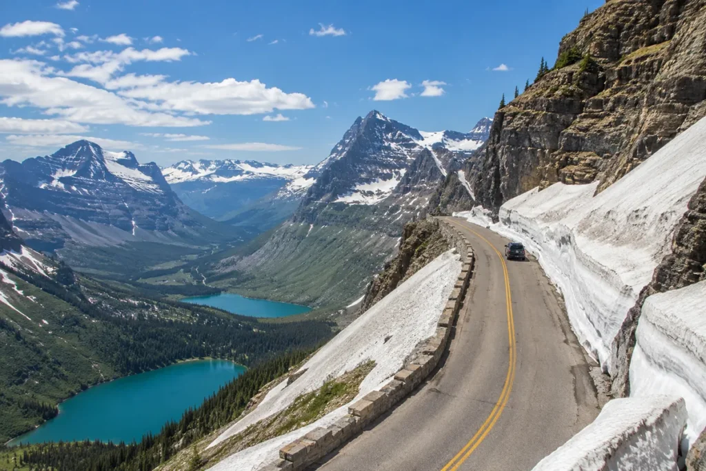 Going-to-the-Sun Road in Glacier National Park Montana showing the winding mountain road at Logan Pass with snow walls in June