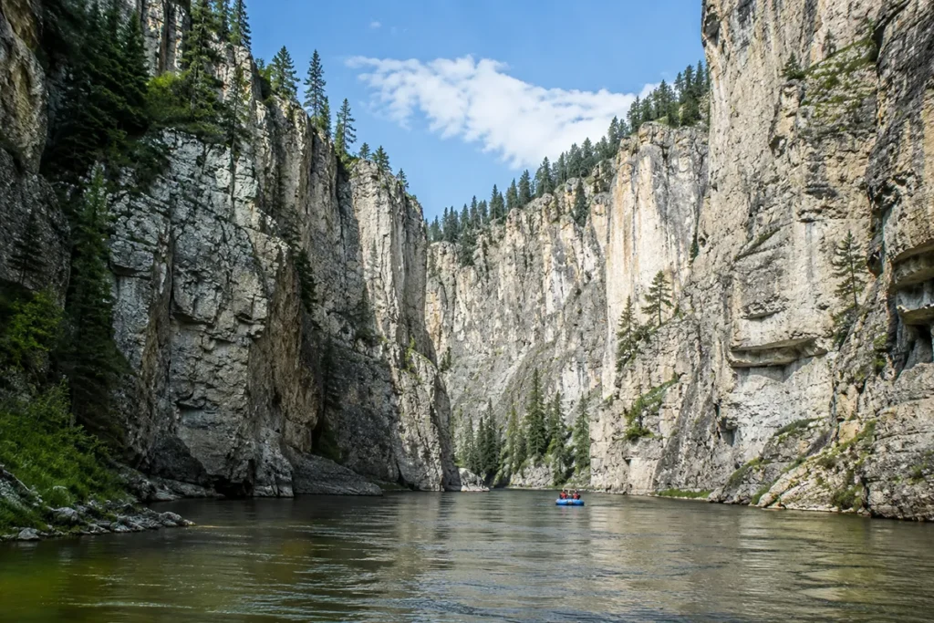 Limestone canyon walls rising above the Smith River during a multi-day float trip in Montana