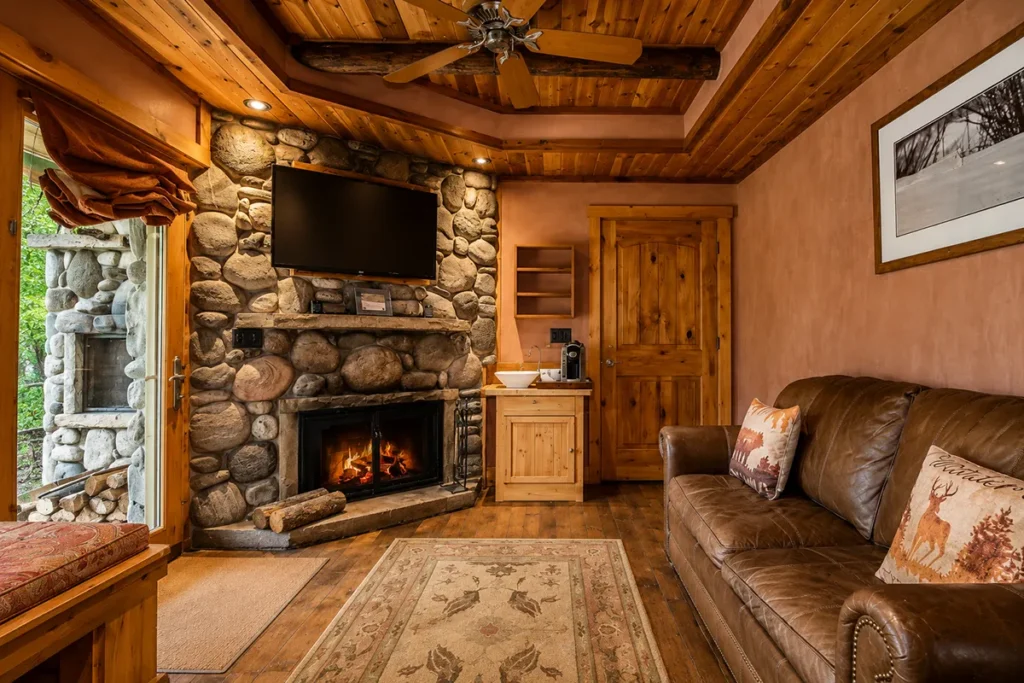 Rainbow Ranch Lodge Montana lounge with river rock fireplace leather couches and award winning wine list at the intimate 21-room lodge on the Gallatin River