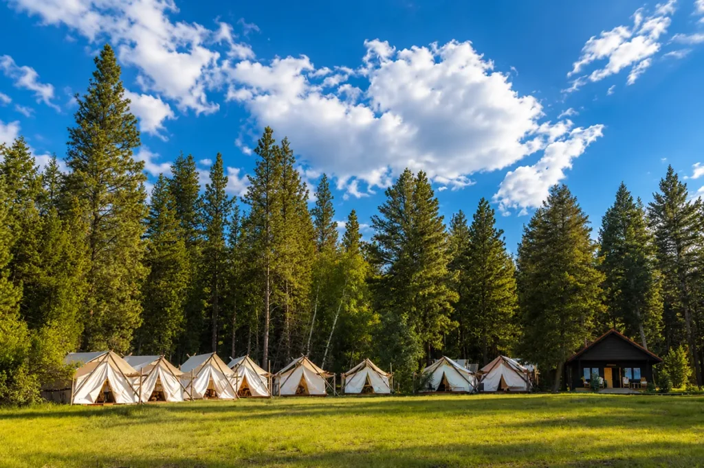 Spa Town at Paws Up Montana showing the private canvas treatment tents in a meadow with mountain views for wellness treatments