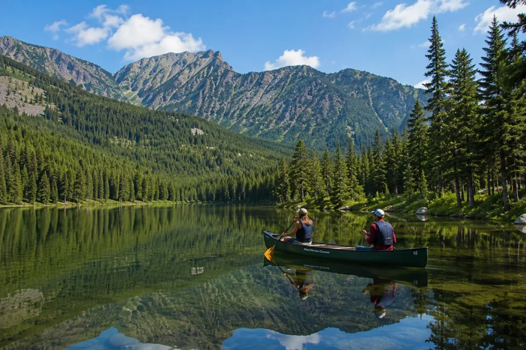 Spencer Lake at Bar W Guest Ranch Montana showing the mountain lake with canoes and pine forest surrounding it