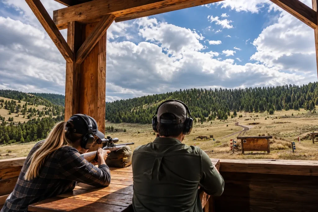 The Rod and Gun Club at the Ranch at Rock Creek Montana showing shooting ranges and the equipment rental center with mountain peaks behind