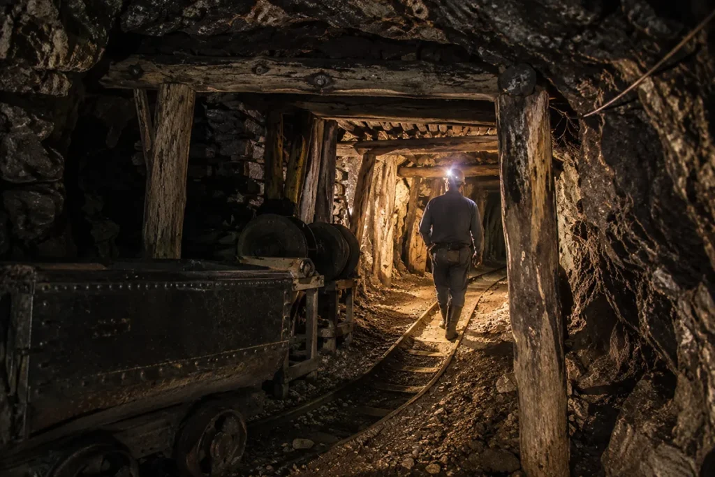 Visitors wearing hard hats and headlamps on the underground mine tour at World Museum of Mining