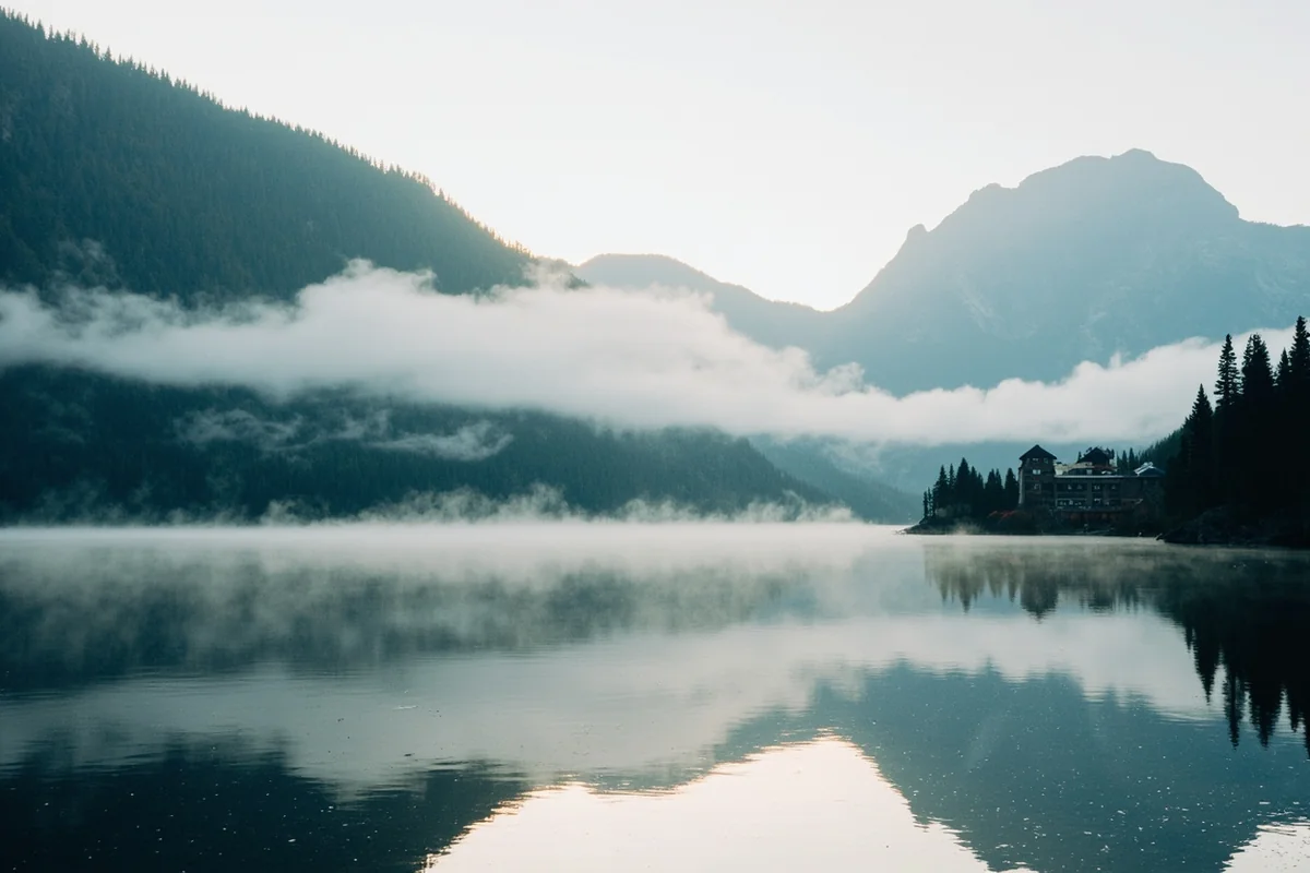 Early morning fog lifting off Swiftcurrent Lake with the Many Glacier Hotel visible in the distance
