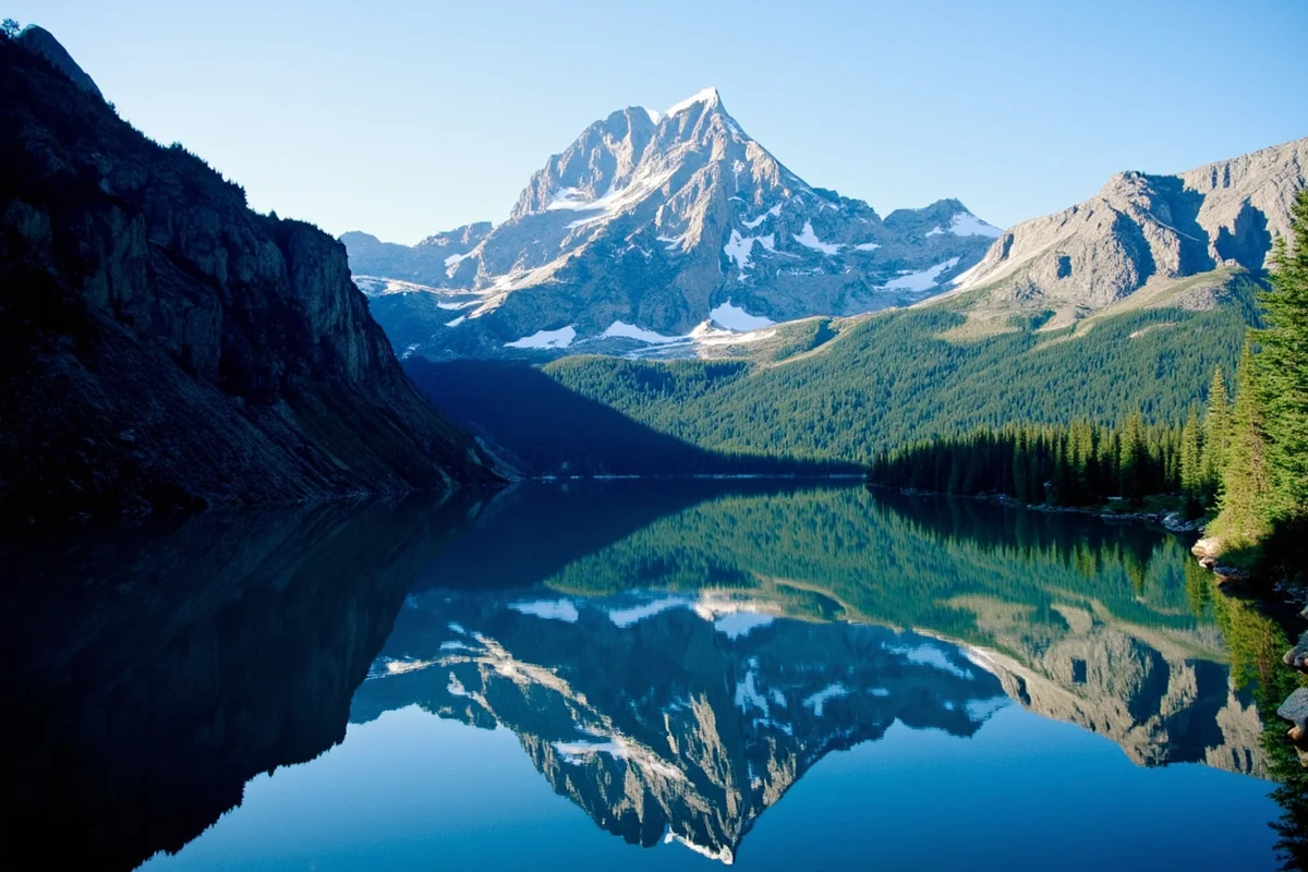 Mount Wilbur and Iceberg Peak towering over Iceberg Lake casting deep shadow