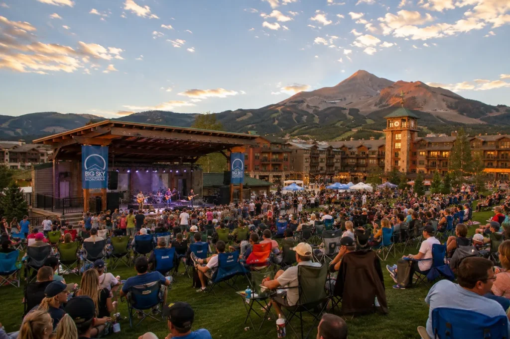 Music in the Mountains free outdoor concert at Len Hill Park in Big Sky Montana on a summer evening with mountains behind