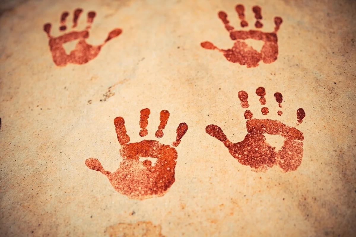 Pictograph handprints on a limestone canyon wall along the Smith River