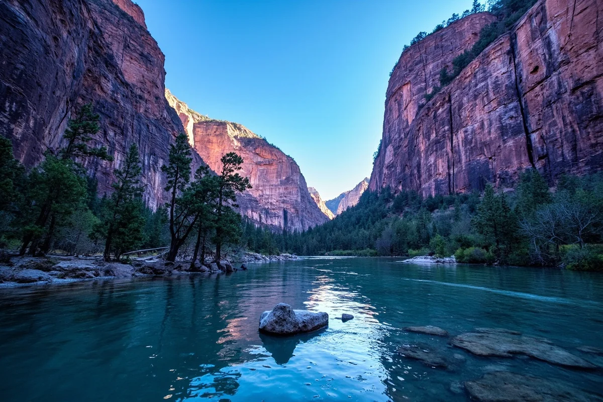 Purple-hued canyon cliffs rising above the Clark Fork River in Alberton Gorge, Montana