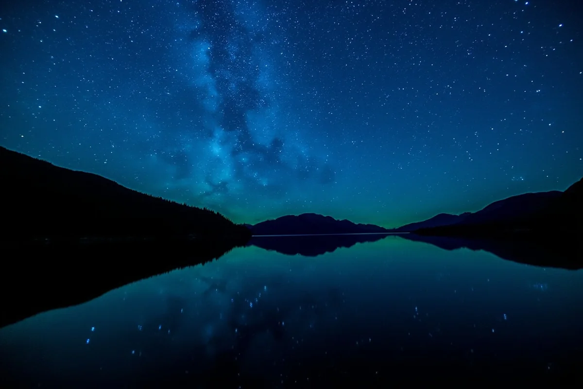 Starry night sky over Kintla Lake in Glacier National Park's dark sky region