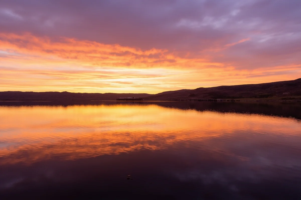 Sunset over Fort Peck Lake in eastern Montana with the dam visible in the distance